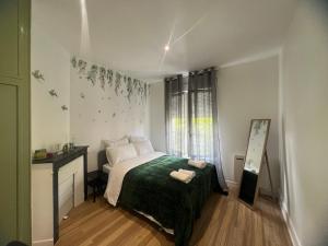 a bedroom with a bed and a desk and a window at Modern Renovated Apartment -15 min Orly airport in Viry-Châtillon