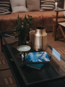 a glass coffee table with a vase on top of it at Infinity Hotel & More in Budva