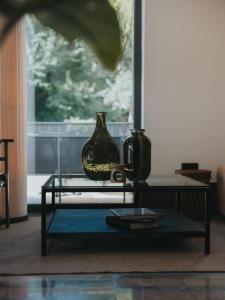a glass table with two vases on top of it at Infinity Hotel & More in Budva