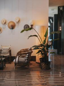 a room with a potted plant and a couch at Infinity Hotel & More in Budva