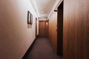 a hallway with wooden walls and a hallway with a door at Infinity Hotel & More in Budva