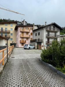 a car parked in a parking lot with buildings at Bilocale baciato dal sole in Andalo