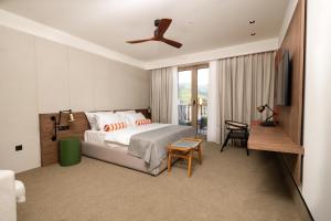 a bedroom with a bed and a ceiling fan at Infinity Hotel & More in Budva