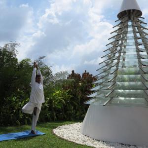 a man sitting on a towel next to a tower at Lanka Princess All Inclusive Hotel in Bentota