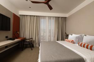 a hotel room with a large bed and a desk at Infinity Hotel & More in Budva