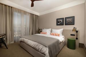 a bedroom with a large bed and a window at Infinity Hotel & More in Budva