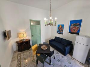 a living room with a blue couch and a table at Lu Màri case vacanze in Balestrate