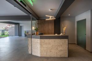 an office with a reception desk in a lobby at Nerium Apartments Leptokaria in Leptokarya