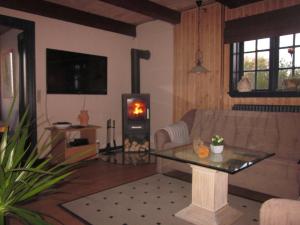 a living room with a couch and a wood stove at Apartment Holmsland in Hvide Sande