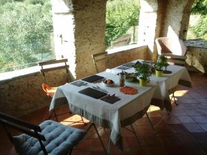 a table with a white table cloth on a room with windows at B&B Ududemà in Dolcedo