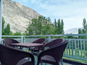 a group of chairs and a table on a balcony at Alpine Resort Khaplu in Khaplu