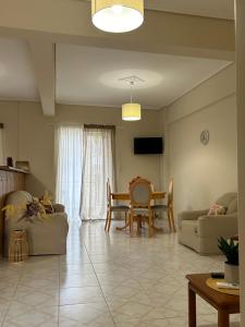 a living room with a couch and a table at K7 House Κέντρο Καλαμάτας in Kalamata