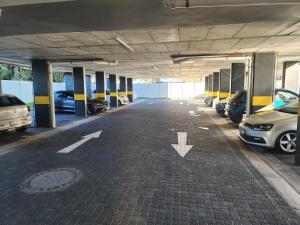 an empty parking lot with cars parked in it at Monty Cosy Haven in Cape Town