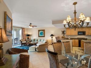 a living room with a table and a dining room at San Remo Condominium 201 by Newman-Dailey in Santa Rosa Beach