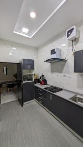 a kitchen with black and white appliances and a table at Eco luxury apartments- Lekki Phase 1 in Lekki