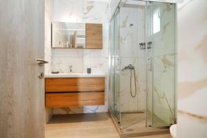 a bathroom with a shower and a sink at Nikiti Cozy Summer Maisonette in Skála Nikíta