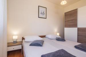 Postel nebo postele na pokoji v ubytování Apartments Miljenko