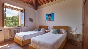 a bedroom with two beds and a window at San Demetrio in Castelnuovo Berardenga +38 photos