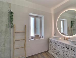 a bathroom with a sink and a mirror at La Bohème Mouriès in Mouriès +62 photos