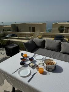 a table with plates of food on top of a couch at Dua Green Coast in Palasë