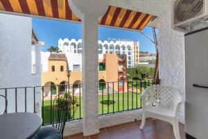a balcony with a view of a city at Renovated apartment on beachside with pool in Nerja