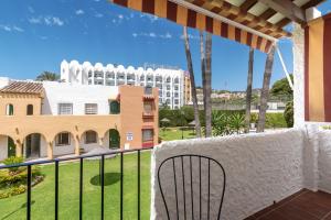 a balcony with a view of a building at Renovated apartment on beachside with pool in Nerja
