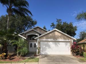 a house with a garage and a palm tree at Upgraded Pool Villa Spa Southern Dunes in Haines City