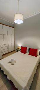 a bedroom with a large bed with red pillows at Allin home in Mantoúkion