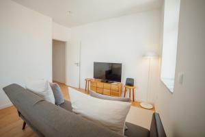 a living room with a couch and a tv at Douro Panoramic Views by Vacationy in Bandeira