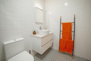 a white bathroom with a sink and a toilet at Douro Panoramic Views by Vacationy in Bandeira +18 photos