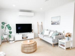 a living room with a couch and a tv at 59 Short in Nambucca Heads