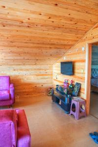 a living room with a wooden wall and a couch at bulepe SUİT APART in Rize +54 photos