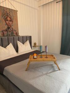 a bed with a table with two candles on it at C14 Apartment 1 in Paralia Katerinis