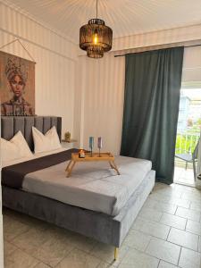 a bedroom with a large bed with a table on it at C14 Apartment 1 in Paralia Katerinis