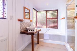 a bathroom with a sink and a bath tub at Peak's Cabin - Endless Ocean Views - Fireplace - Fast WiFi in Wilderness +41 photos