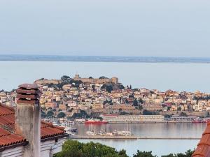 a view of a city with boats in the water at Pinecone in Kavala