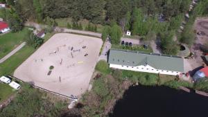 an aerial view of a building next to a lake at Stajnia Czahary in Pogorzelica