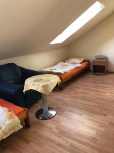 a living room with two beds and a couch at Stajnia Czahary in Pogorzelica