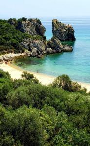 a beach with a group of people in the water at Paradise in Loutrá Elevtherón