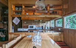 a dining room with a wooden table in a house at Beautiful Home In Jordet in Jordet