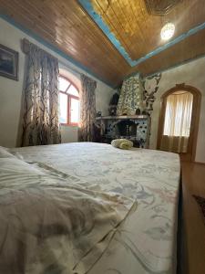 a large bed in a room with a window at Villa Zeko in Gjirokastër