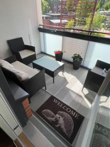 a living room with a table and chairs and a table at SiilinPiha central apartament Siilinjärvi in Siilinjärvi