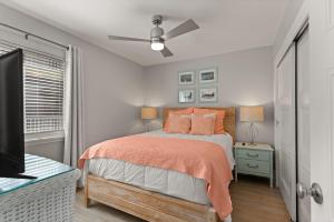 a bedroom with a bed and a flat screen tv at Shipwatch, Unit 113 - 1524 Wood Avenue in East End +15 photos