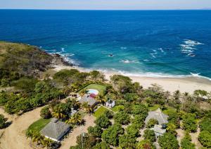 an aerial view of a house and the beach at Cabañas Linda Vista in Chimo +3 photos