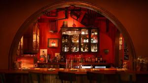 a bar with an arch in a red room at Hidden Gem In Miramar- Power Generator- Parking in San Juan