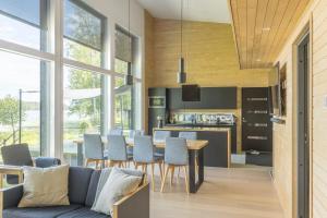 a kitchen and living room with a couch and a table at Villa Bläk in Alavus