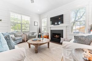 a living room with a fireplace and a tv at Uncloudy Day - 1216 Demere Road in Mallory Park