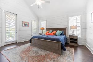 a bedroom with a bed and a ceiling fan at Uncloudy Day - 1216 Demere Road in Mallory Park +30 photos