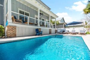 a swimming pool in front of a house at Uncloudy Day - 1216 Demere Road in Mallory Park