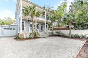 a house with palm trees in front of it at Uncloudy Day - 1216 Demere Road in Mallory Park